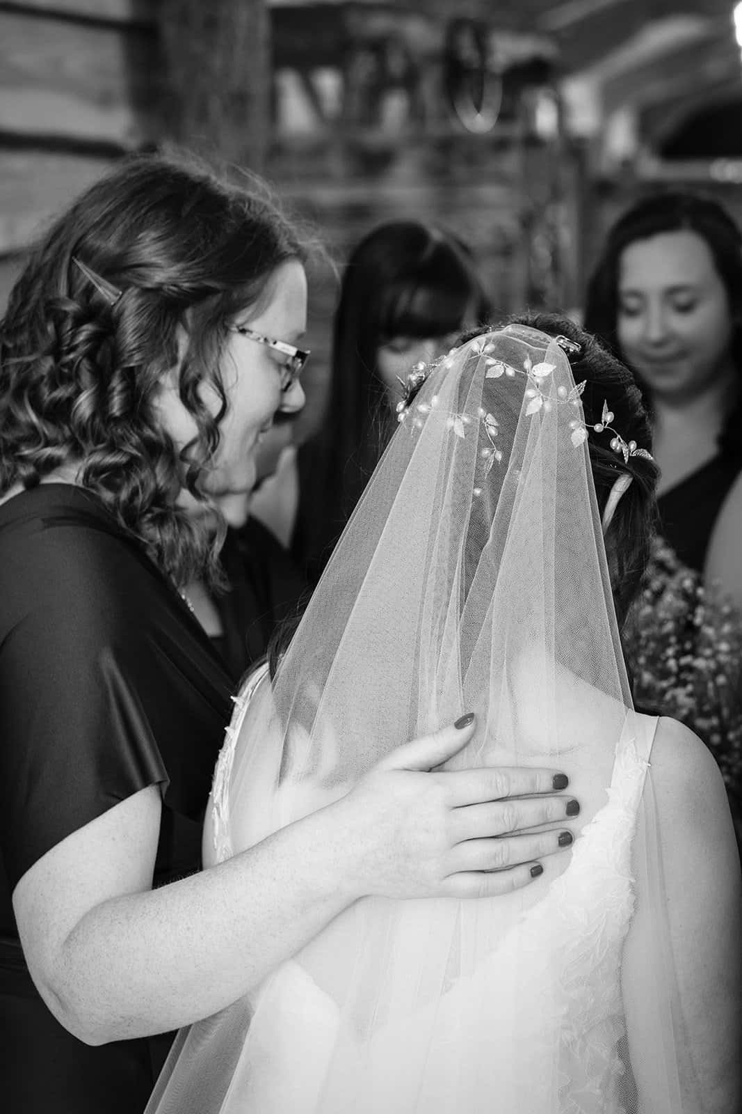 Bride sharing a quiet moment with a friend before the ceremony