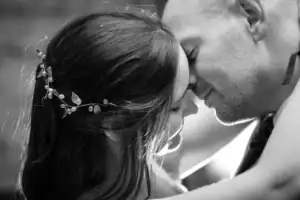 Newlywed couple embracing in black and white close-up image