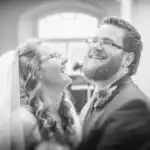 Bride and groom laughing joyfully at wedding ceremony