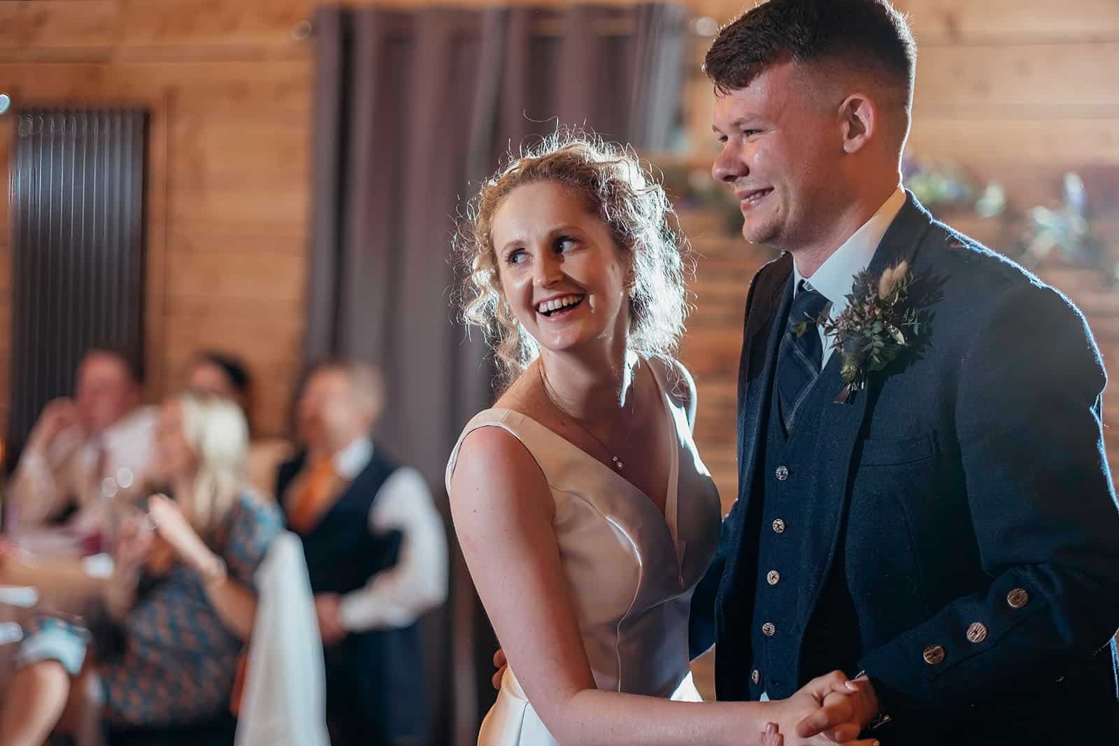 A joyful couple dancing at their wedding reception