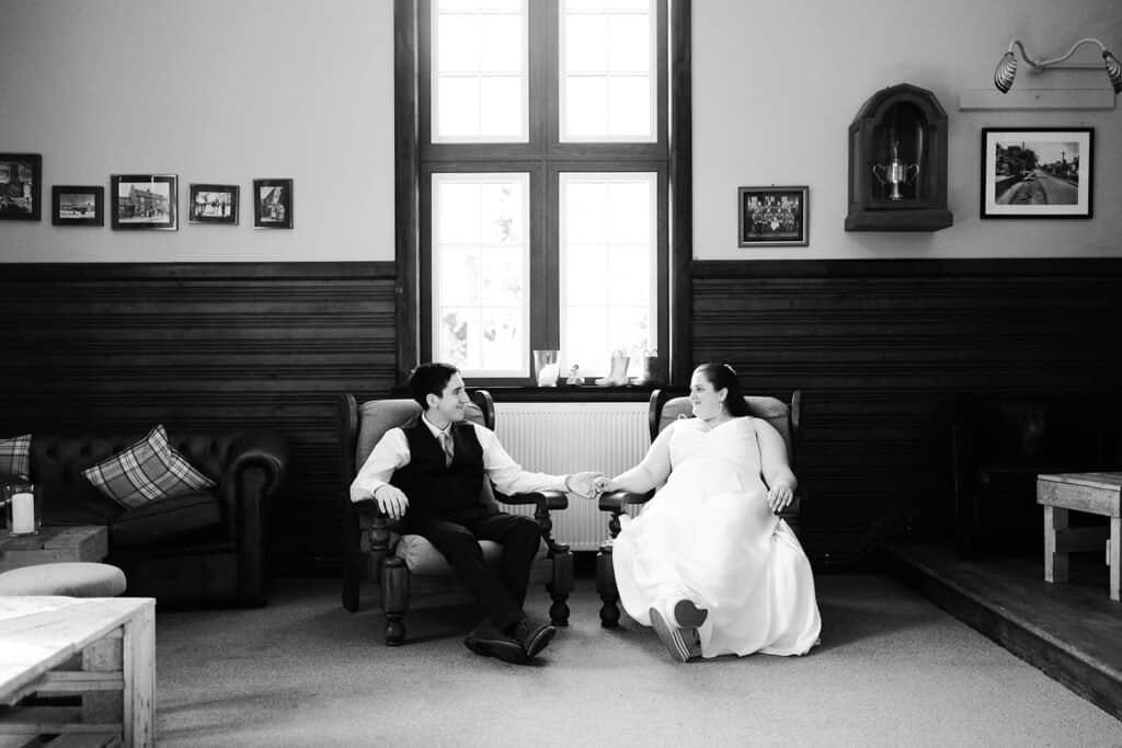 Bride and groom sitting in a cozy room with elegant decor