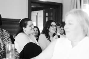 Bride smiling with love as her groom gives his speech