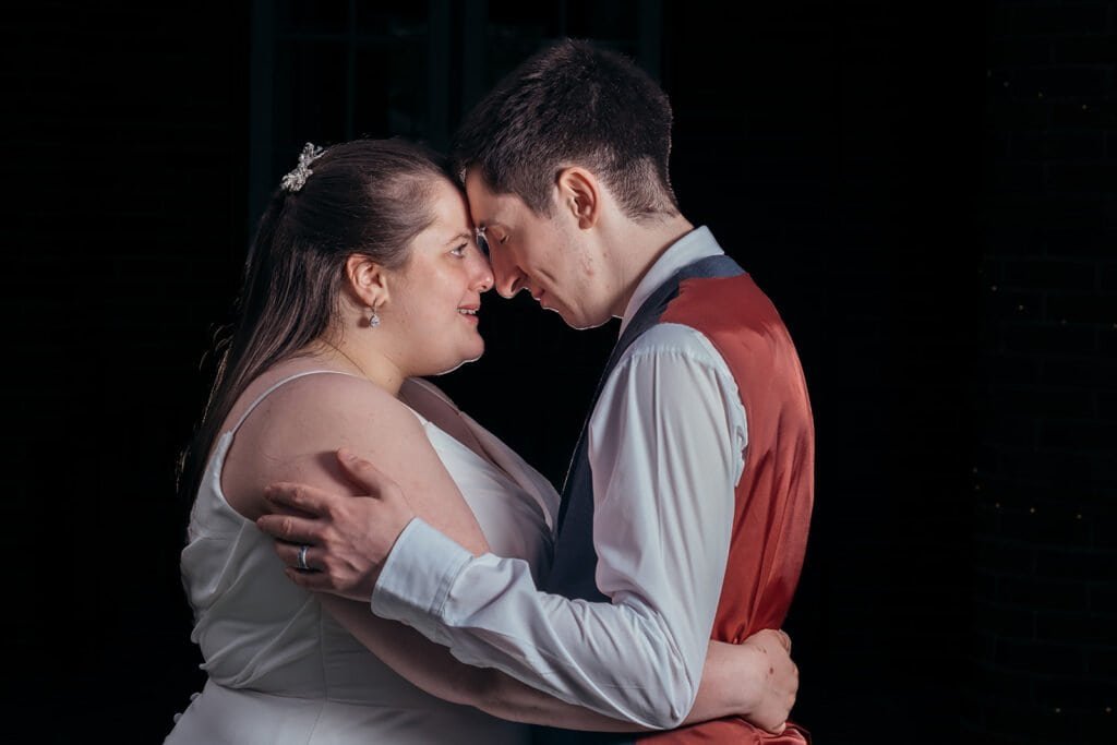 Bride and groom sharing a heartfelt embrace at wedding