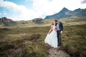 Bride and groom share a romantic kiss in scenic mountains