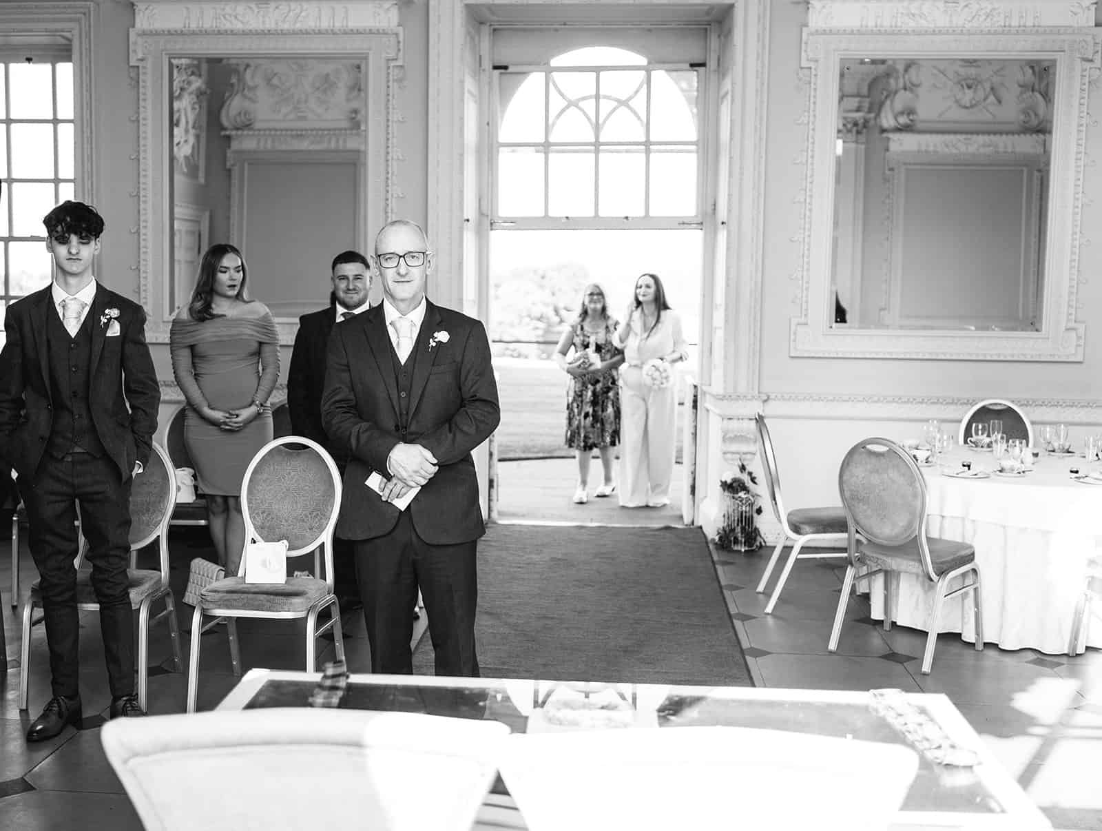 Guests gather in elegant room for special occasion event