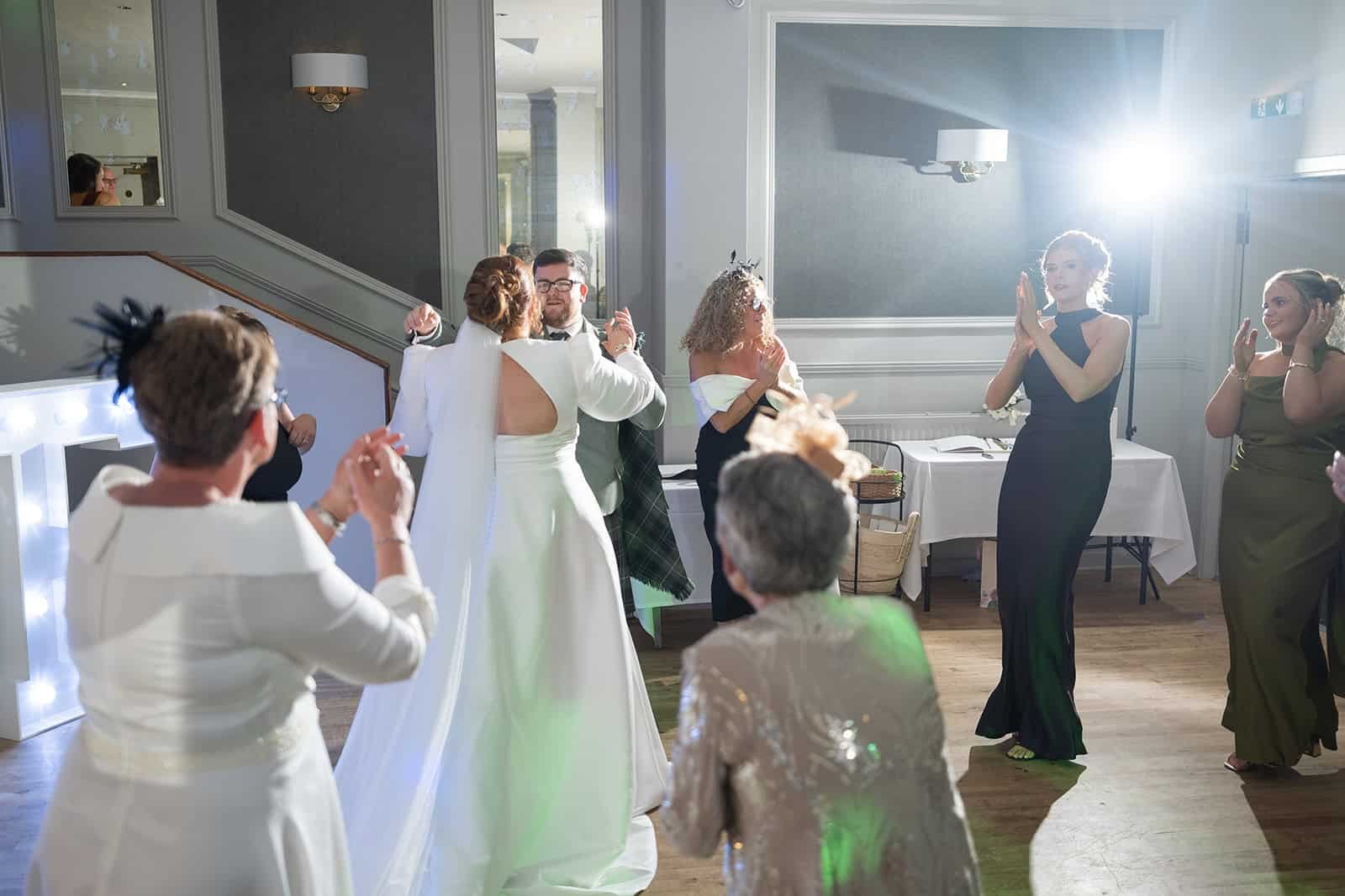 Guests enjoying dancing at a vibrant wedding reception event