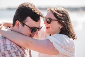 Happy couple enjoying a sunny day near the water.