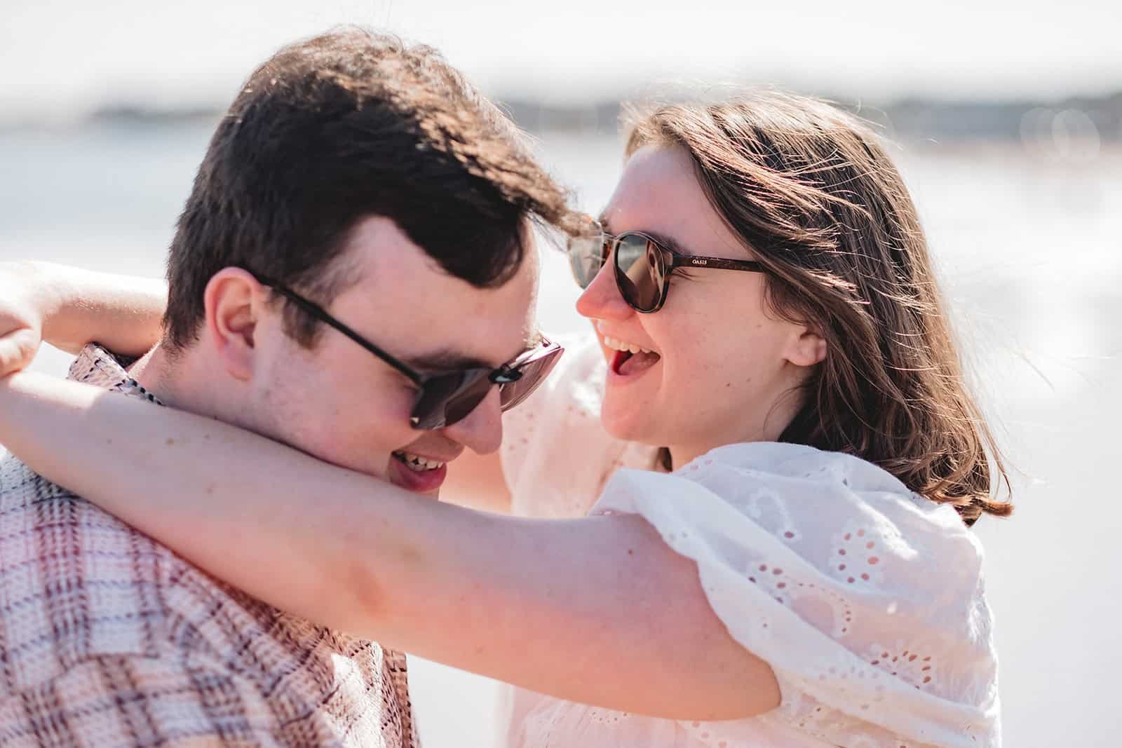 Happy couple enjoying a sunny day near the water.