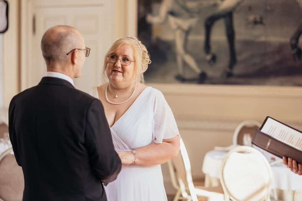 Bride and groom exchange vows in elegant wedding ceremony at Chatelherault