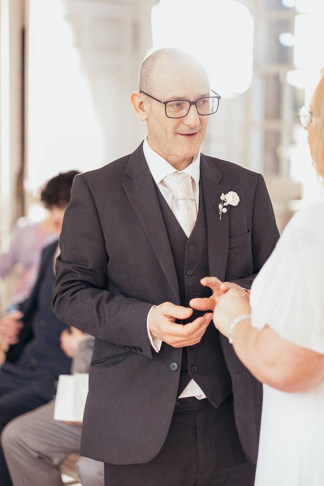 Elderly couple exchanging wedding vows at ceremony