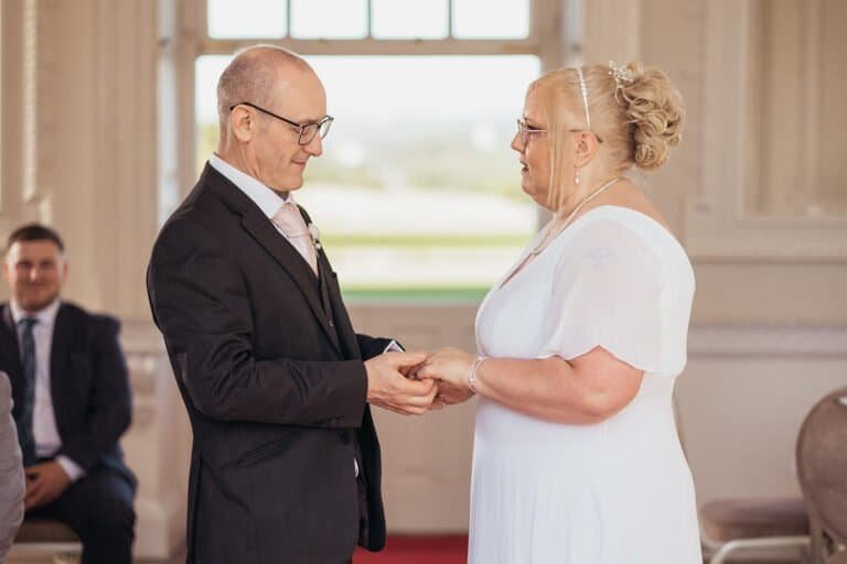 Older couple exchanging vows during their wedding ceremony