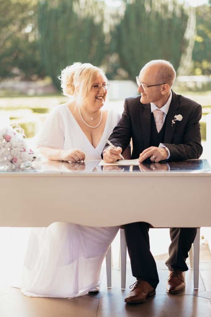 Happy couple signing wedding registry at Chatelherault