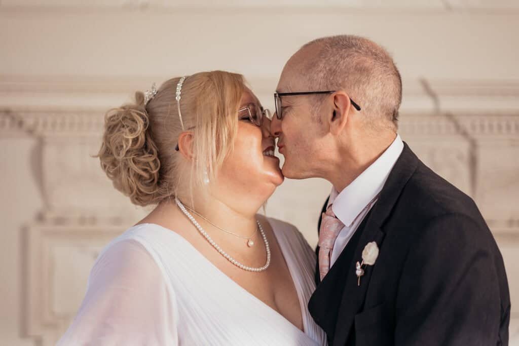 Couple sharing a joyful kiss on their wedding day in Chatherault, Hamilton