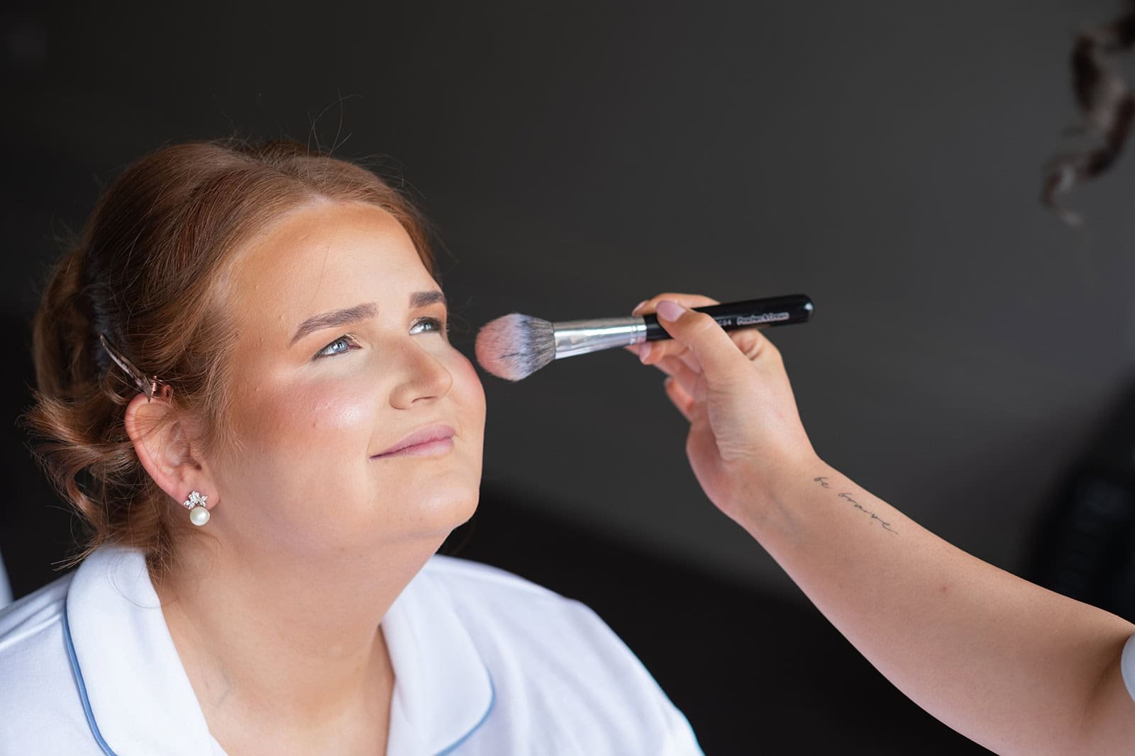 Woman enjoying professional makeup application session