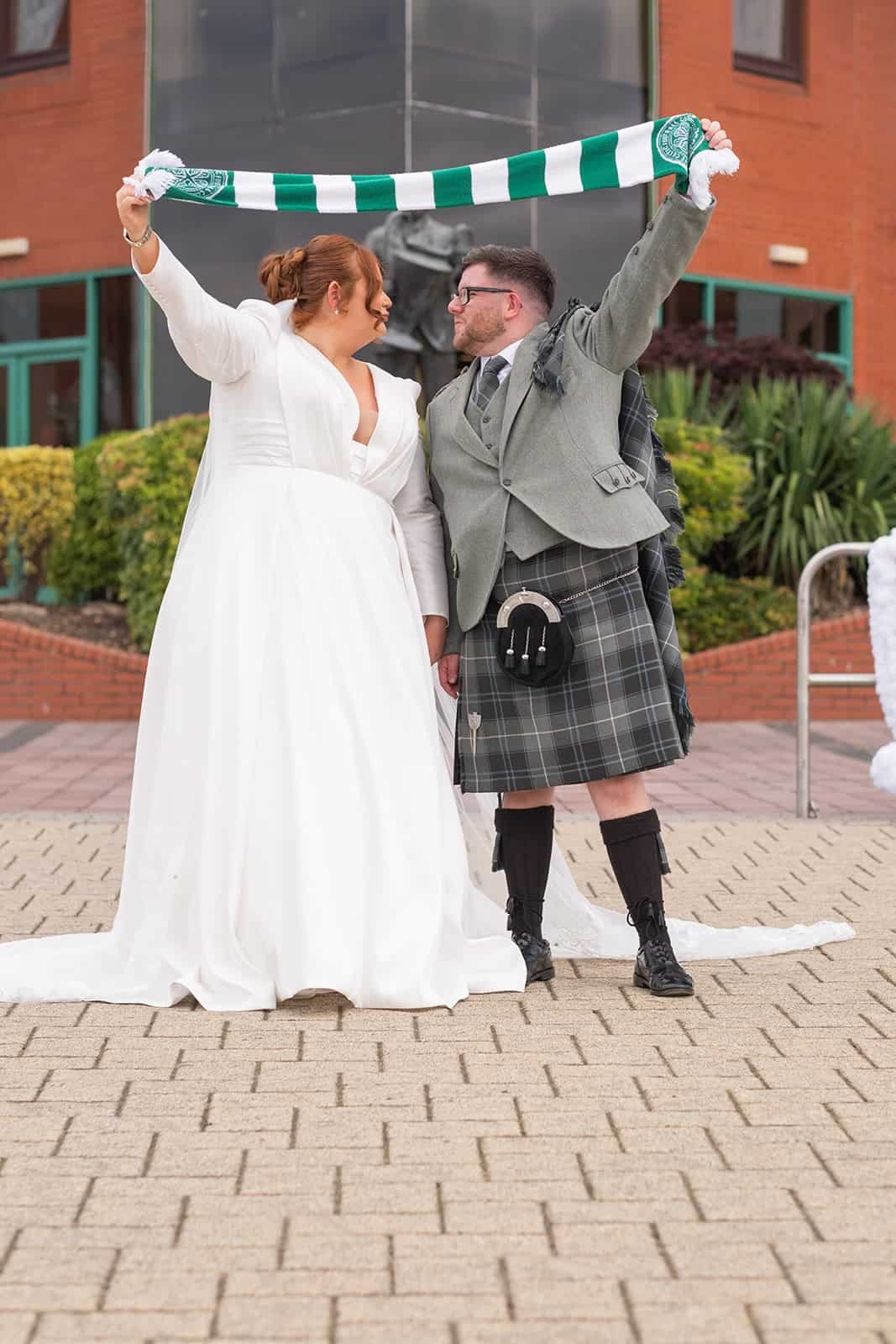 Bride and groom celebrate with football scarf at Celtic Park