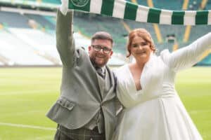 Happy couple celebrating wedding at a football stadium