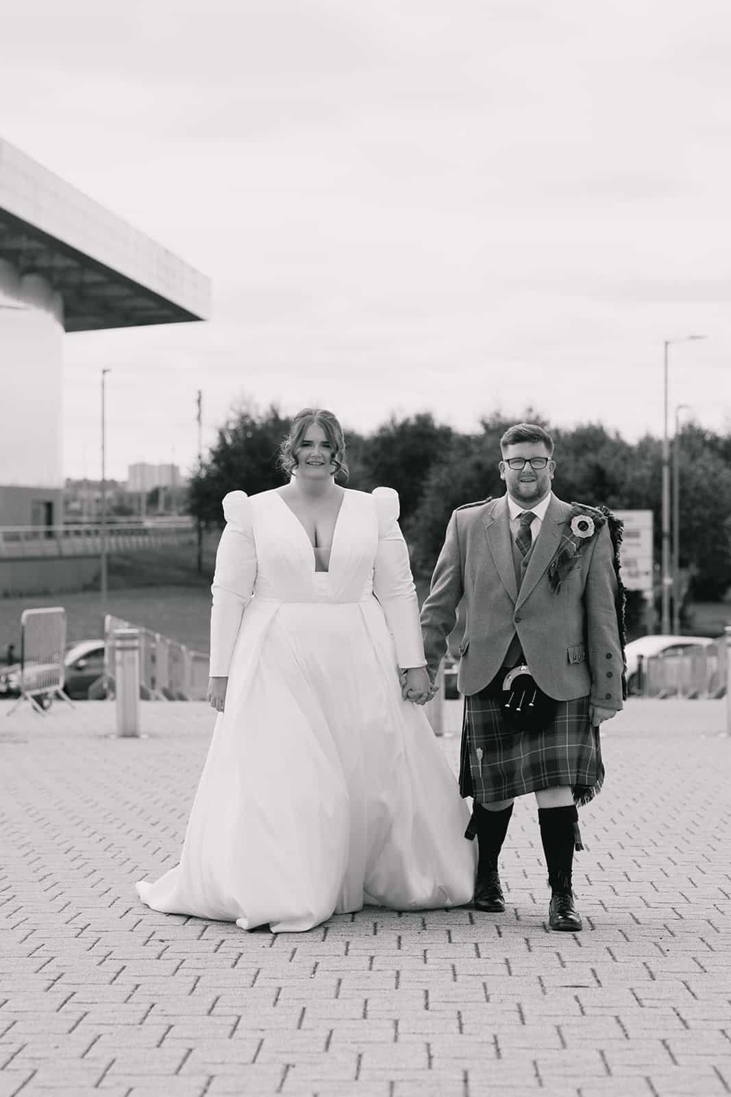Wedding couple in front of iconic Celtic Park stadium in Scotland