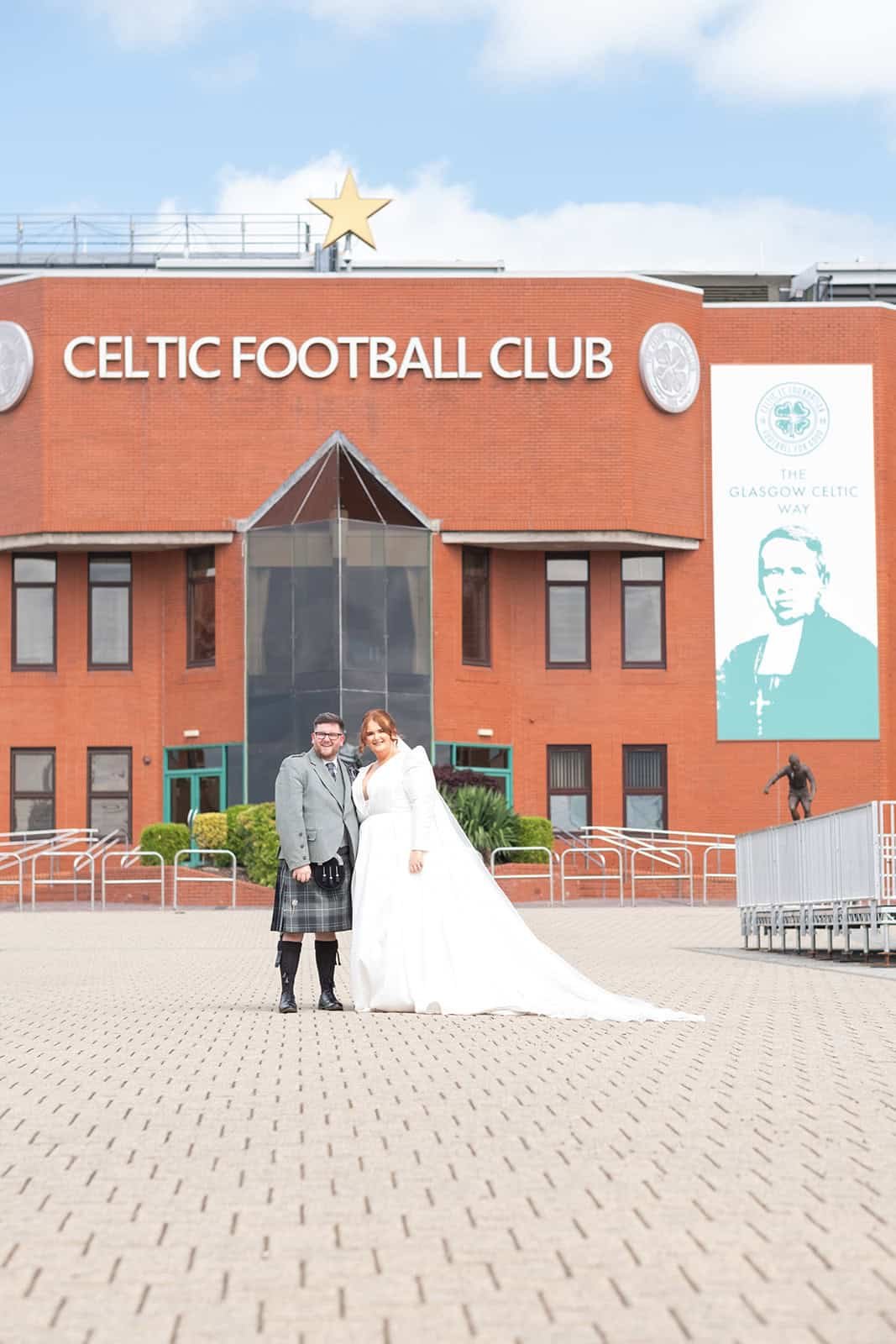 Bride and groom smiling outside Celtic Football Club stadium