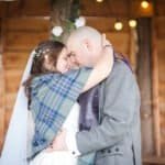 Bride and groom embrace in rustic wooden barn at Silverwood Resort Perth