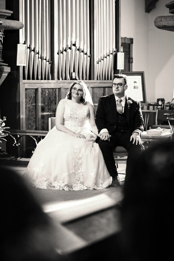 Bride and groom holding hands during wedding ceremony
