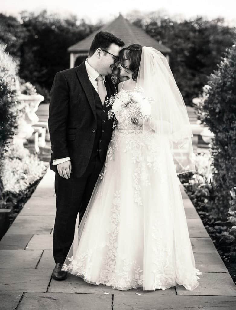 Bride and groom sharing a moment in a beautiful garden setting