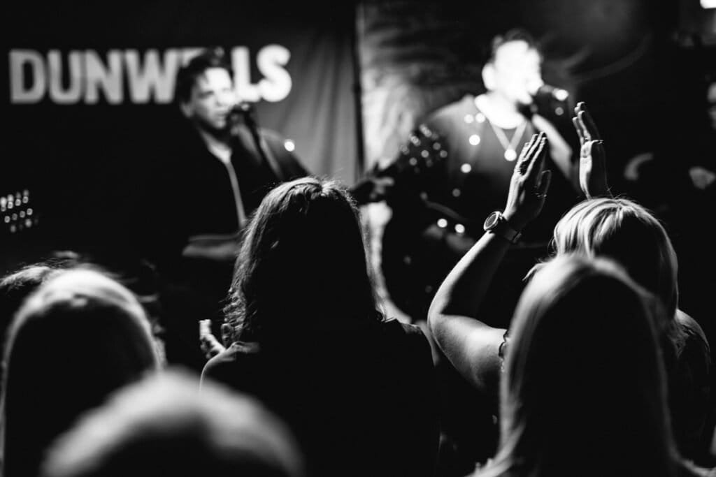 Live band performing on stage with cheering audience