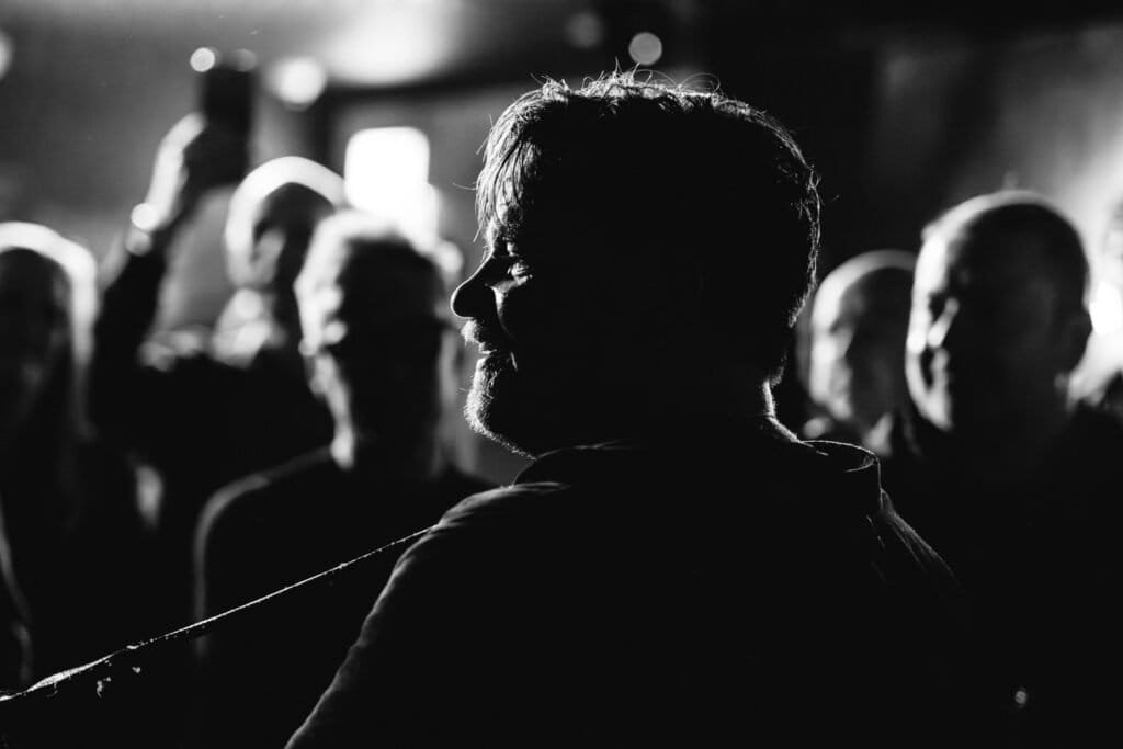 Black and white silhouette concert scene with guitarist performing