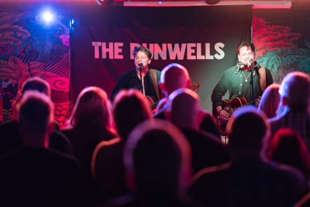 Live band performance on stage with audience watching