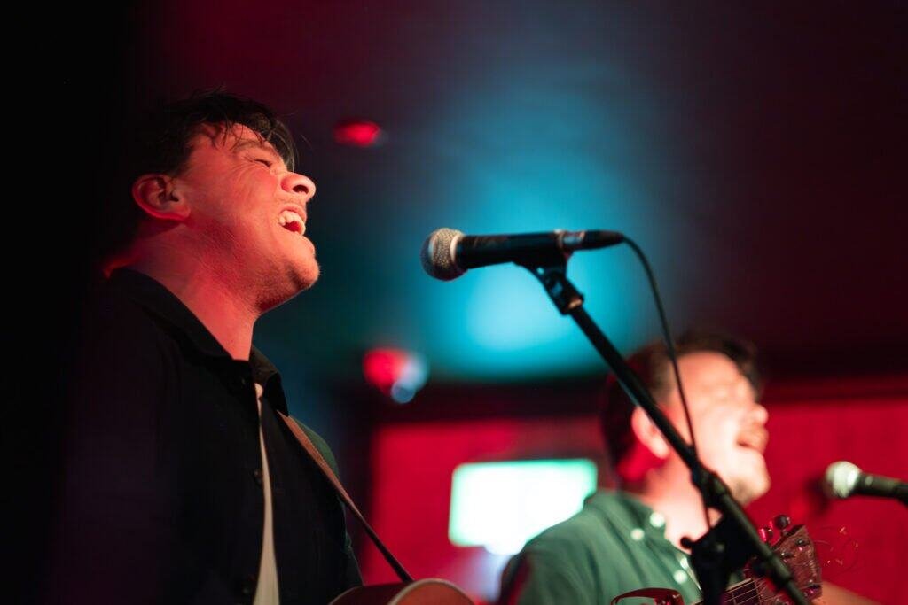 "Musicians performing live with energy and passion on stage"