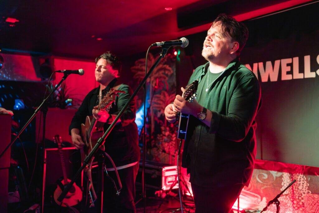 Musicians performing live at an indoor music venue stage