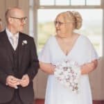 Bride and groom smiling during their wedding ceremony at Chatelherault