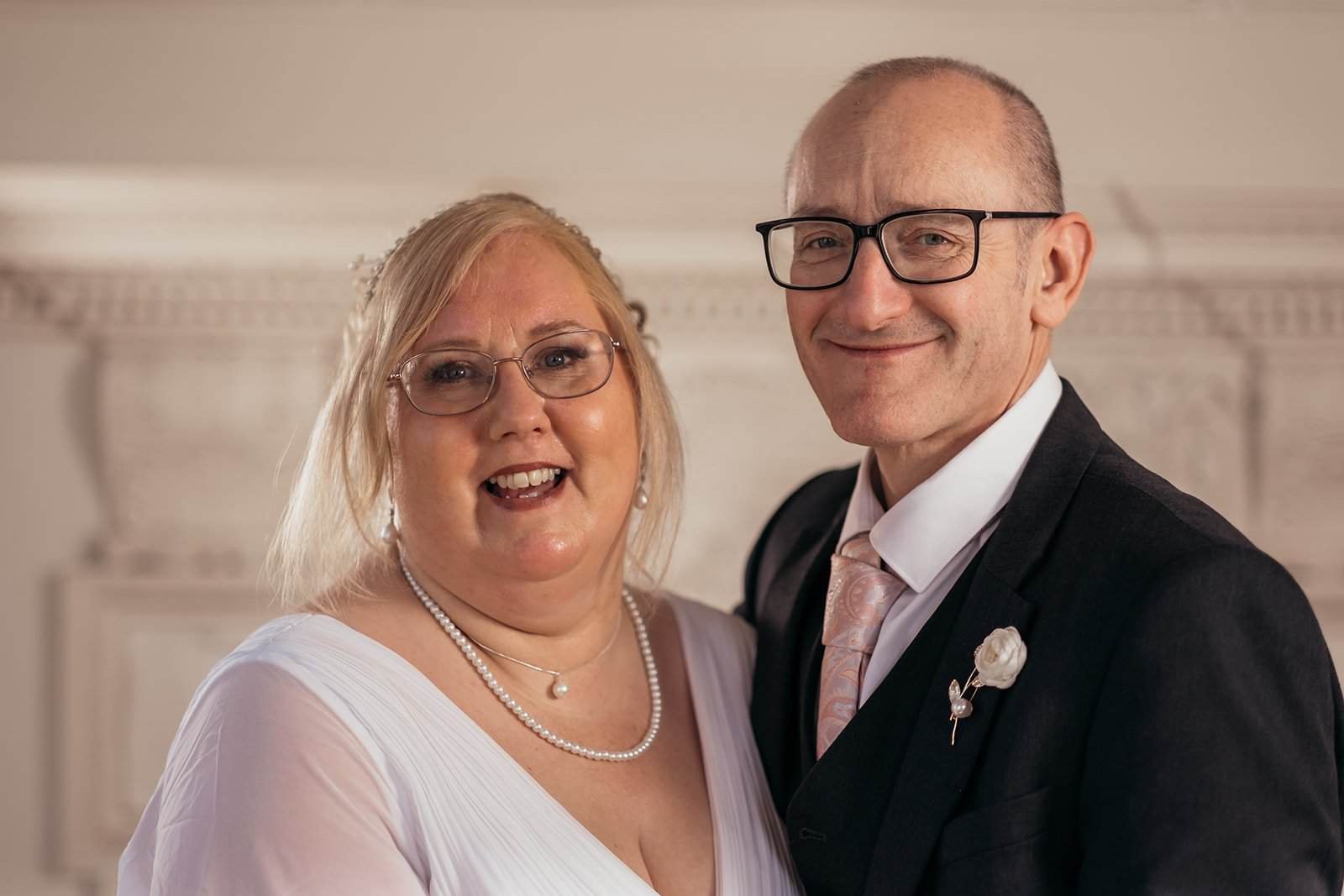 Smiling couple in formal attire at a celebration event