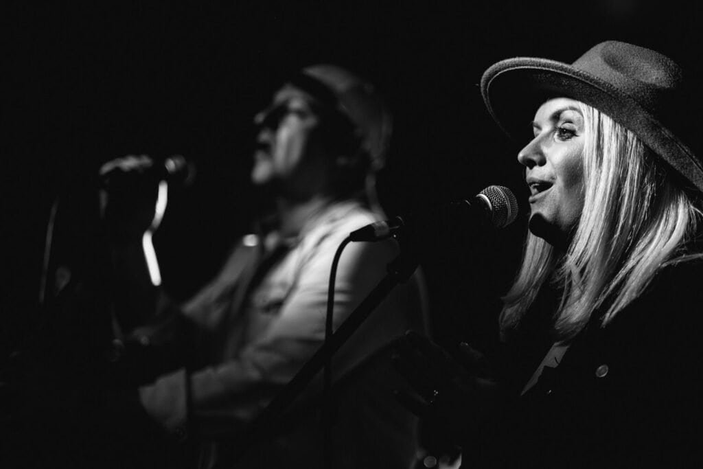 Singers performing on stage in black and white photography