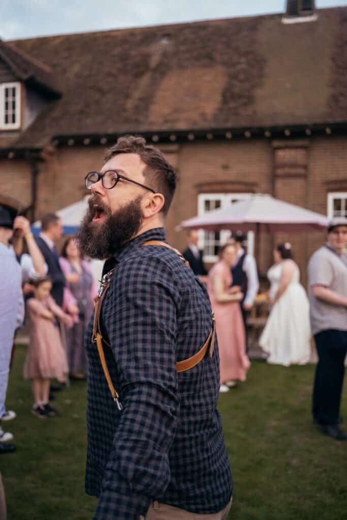 Steven photographing a wedding, camera in hand