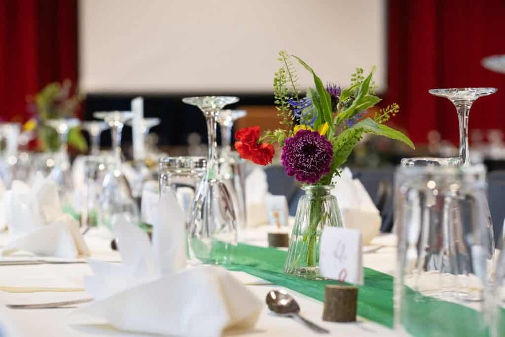Elegant table setting with floral centerpiece in a banquet hall