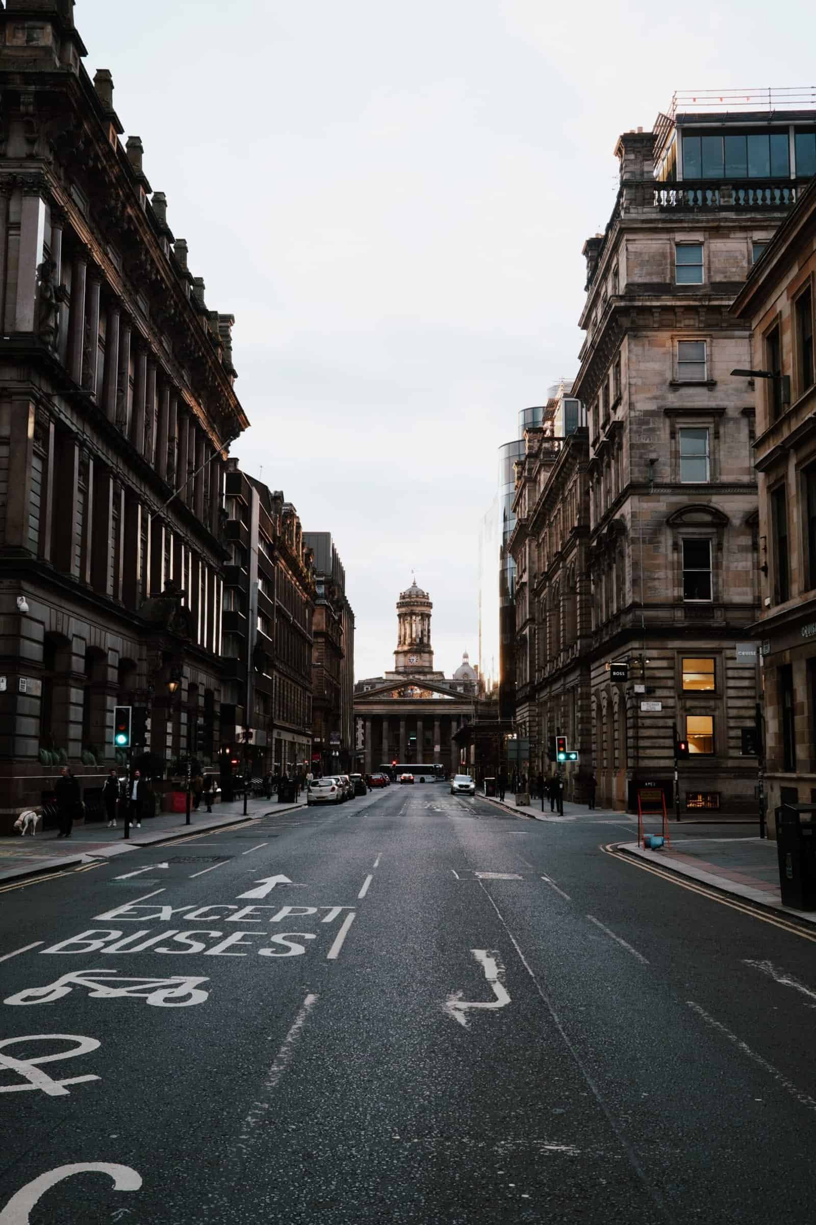 A historic Glasgow street looking towards the Gallery of Modern Art at dusk